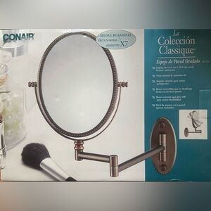 Conair Oval Wall Mount Mirror in oil-rubbed bronze. 6.5” X 8.5” diameter.